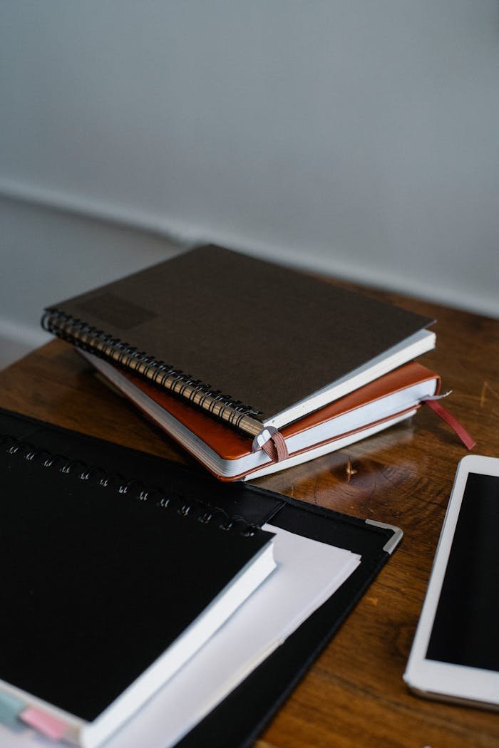 Workspace with notebooks and tablet on table