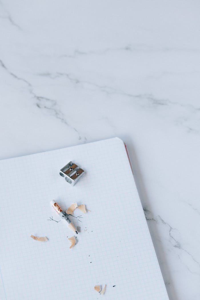 Sharpener and Pencil on Top of Stationery