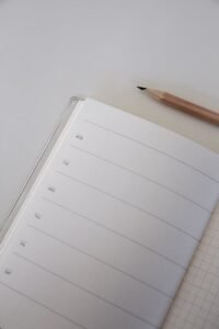 A Brown Pencil Beside a Journal